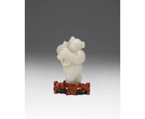 A CHINESE PALE CELADON JADE CARVING OF A BOY 18TH/19TH CENTURY The boy riding a hobby horse, with his right hand holding a lo