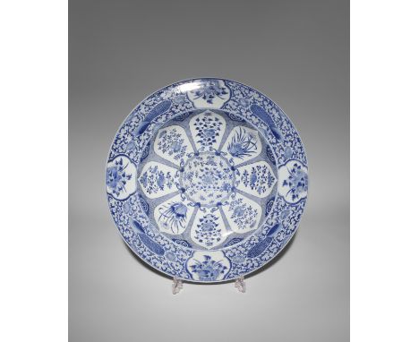 A MASSIVE CHINESE BLUE AND WHITE 'PEACOCK' DISH KANGXI 1662-1722 Painted in the centre with a blossoming peony sprig enclosed