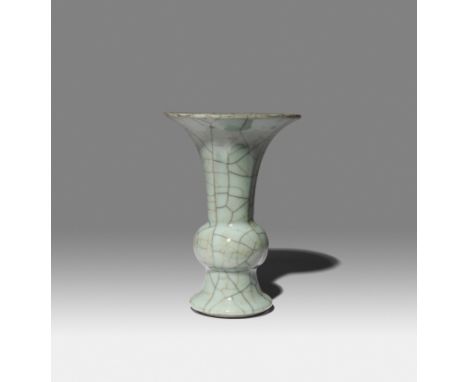 A CHINESE ARCHAISTIC GUAN-TYPE BEAKER VASE, GU QING DYNASTY OR LATER Covered overall in a bluish-grey glaze, suffused with a 