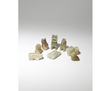 EIGHT SMALL CHINESE ARCHAISTIC CELADON AND YELLOW JADE 'ANIMAL' PENDANTS PROBABLY QING DYNASTY Variously carved as stylised b