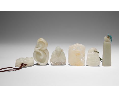SIX CHINESE CELADON JADE CARVINGS QING DYNASTY Comprising: one carved as a cat lying on a palm fan with a large dragonfly per