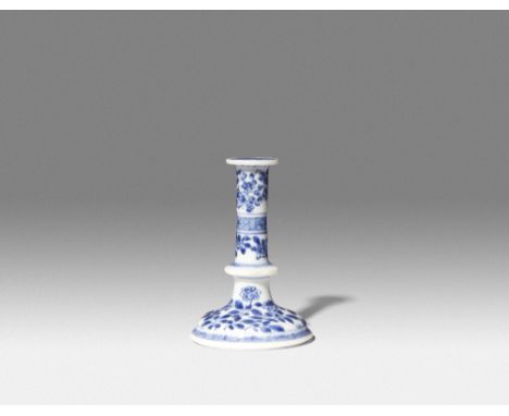 A CHINESE BLUE AND WHITE MINIATURE CANDLESTICK KANGXI 1662-1722 Rising from a domed circular foot, with a knopped stem, paint