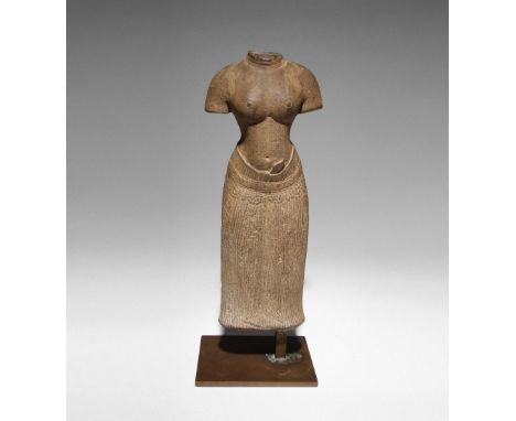 A KHMER BAPHUON STYLE SANDSTONE CARVING OF A FEMALE TORSO 11TH CENTURY OR LATER Standing in samabhanga, her naked upper body 