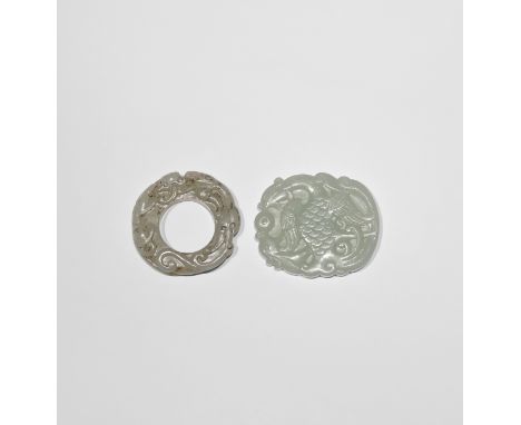 TWO CHINESE PALE CELADON JADE PENDANTS QING DYNASTY OR LATER One carved with a writhing kui dragon and a phoenix stretching i