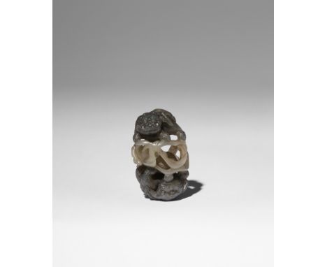 A SMALL CHINESE GREY AND CELADON OPENWORK JADE CARVING OF BUDDHIST LIONS QING DYNASTY Carved as two crouching Buddhist lions 