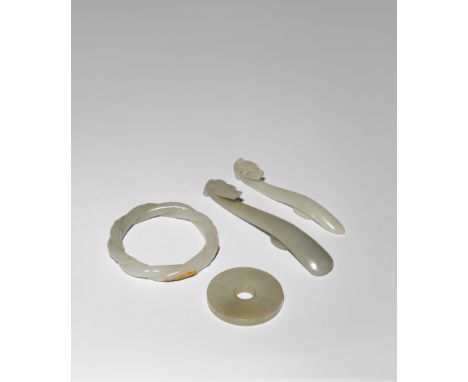 FOUR CHINESE PALE CELADON JADE ITEMS QING DYNASTY OR LATER Comprising: two belt hooks with dragon head terminals, a bi disc c