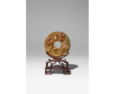 A CHINESE ARCHAISTIC GREENISH-YELLOW JADE BI DISC QING DYNASTY Carved to one side with a chilong clambering around the centra