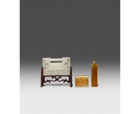 THREE CHINESE CELADON JADE ITEMS QING DYNASTY OR LATER One an archer's ring, carved with a mythical beast, another a hat orna