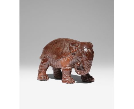 A CHINESE SOAPSTONE CARVING OF AN ELEPHANT LATE QING DYNASTY Standing four-square with its trunk outstretched towards one sid