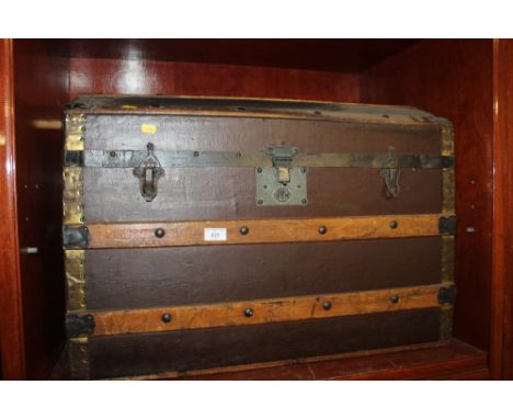 A DOMED WOOD BOUND TRUNK