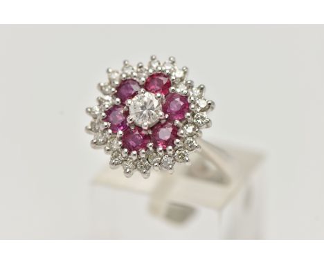 A WHITE METAL RUBY AND DIAMOND CLUSTER RING, flower cluster set with a central round brilliant cut diamond, estimated diamond