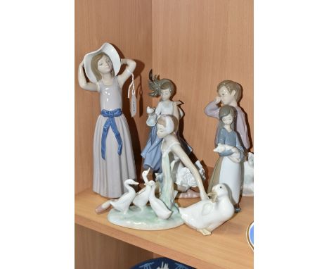 A GROUP OF LLADRO AND NAO FIGURES, comprising Lladro: Trying on a Straw Hat, model no 5011, sculptor Francisco Catala, issued