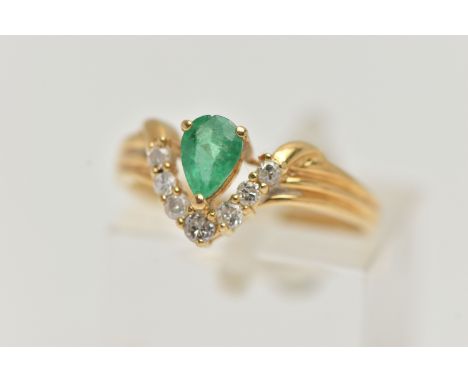 AN EMERALD AND DIAMOND RING, the pear shape emerald with a v-shape line of brilliant cut diamonds beneath, with 18ct import m