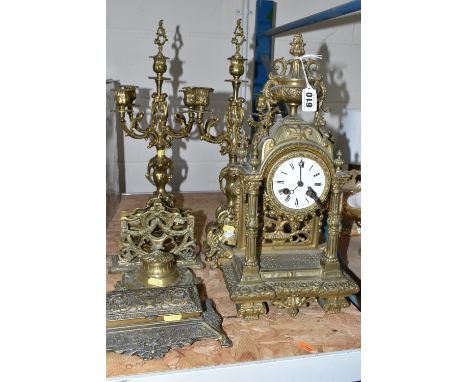 A GROUP OF BRASS WARE, comprising an gilt Rococo style  mantel clock, bell striking mechanism stamped 845 P.R, with key, wind