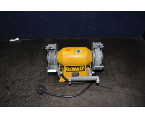 A DeWALT DW754 BENCH GRINDER, fitted with fine disc and polishing discs (PAT pass and working)