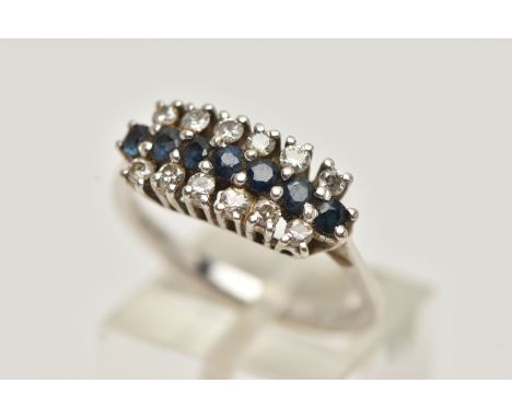 AN 18CT WHITE GOLD DIAMOND AND SAPPHIRE RING, designed with a central row of circular cut blue sapphires, between two rows of