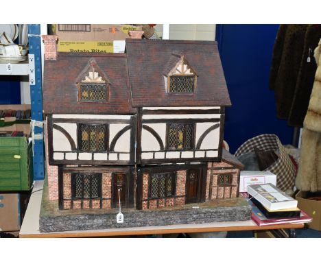 A WOODEN DOLLS HOUSE, modelled as an Elizabethan style half-timbered house, front opening to reveal four rooms over two floor