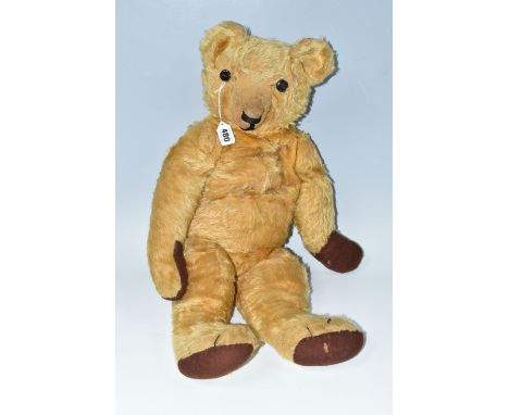 A LARGE WELL LOVED GOLDEN PLUSH TEDDY BEAR, replacement button eyes, horizontal stitched nose, jointed body, replacement felt