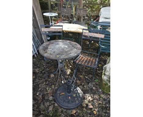 AN IRON AND TILE CIRCULAR FOLDING GARDEN TABLE, a pair of folding chairs, and a parasol stand (condition report: table top ti