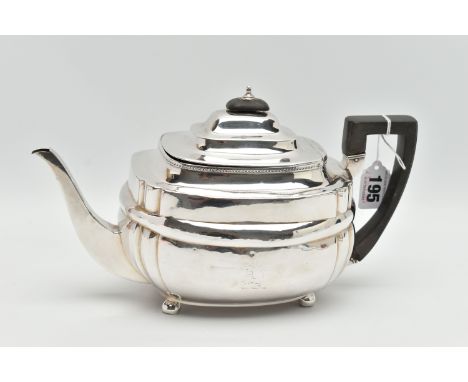 A GEORGE III SILVER TEAPOT, polished form, worn engraved crests to either side, on four ball feet, fitted with an ebonised ha