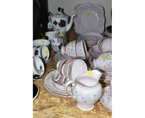 A TUSCAN CHINA TEA SET, a gilt edged pink and grey tulip design on a pink ground, comprising two cake plates, nine cups, elev