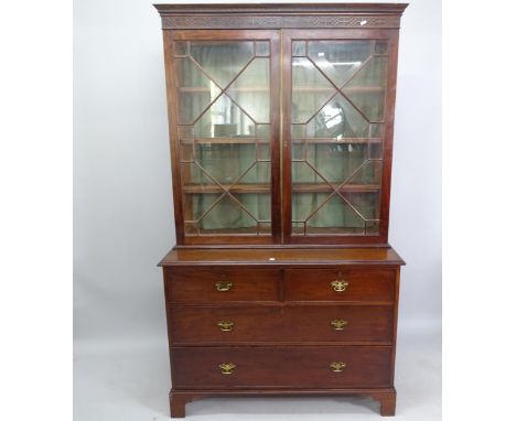 An early 19th century mahogany library bookcase, with lattice-glazed doors, 2 short and 2 long drawers under, on bracket feet