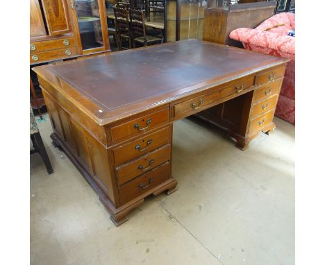 A Victorian mahogany twin-pedestal partners' desk, fitted with tooled and embossed burgundy leather skiver, and each side hav