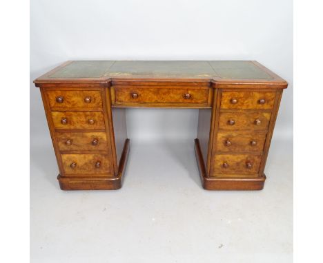 A Victorian walnut kneehole writing desk, with 9 fitted drawers and tooled and embossed green leather skiver, 137cm x 77cm x 