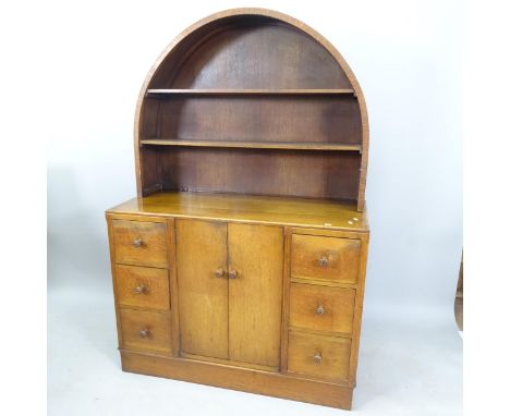 Attributed to Ambrose Heal for Heal & Son, an early 20th century oak dresser, with raised dome-top plate rack above central c