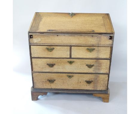 A 19th century oak bureau with well-fitted interior, 2 short and 2 long drawers below, on bracket feet, 89cm x 104cm x 55cm (