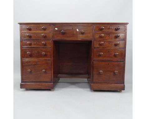 A 19th century mahogany kneehole writing desk, with 11 fitted drawers, 130cm x 85cm x 53cm (with key) 