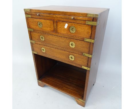 A campaign style hardwood and teak bound side cabinet, with slide and short drawers under, 46cm x 66cm x 30cm 