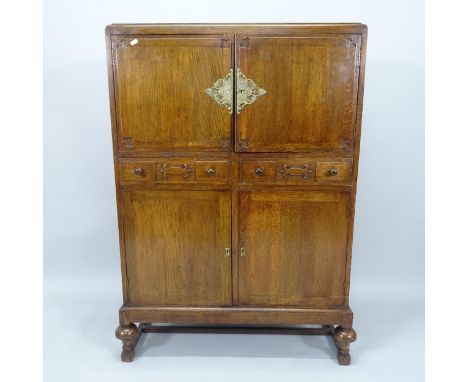 A 1920s oak 4-door cabinet, with 2 fitted drawers, 91cm x 132cm x 41cm (with key) 