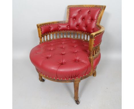 An Antique mahogany circular seated desk chair, with button-backed rexine upholstery 