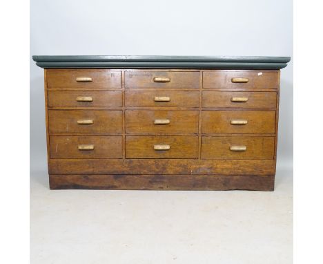 An early 20th century mahogany bank of 16 drawers, with painted wooden top, 153cm x 84cm x 52cm 