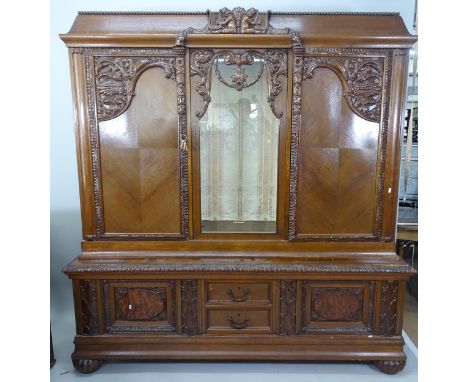 A large 2-section Continental oak cabinet, with glazed and quarter panelled cupboard doors, base fitted with short drawers, a