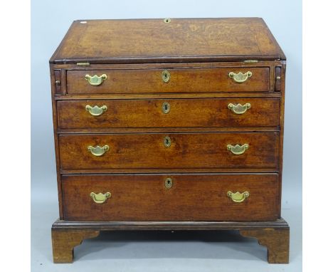 A George III oak bureau, with fitted interior and 4 long graduated drawers, on bracket feet, 83cm x 96cm x 50cm 