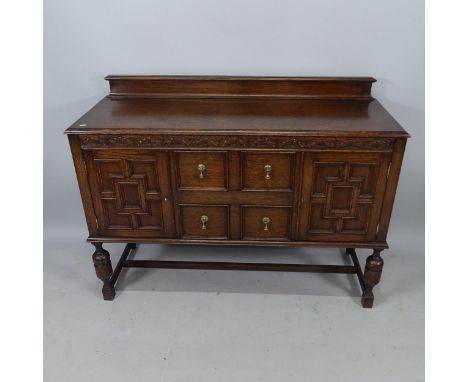 A Jacobean style oak bureau, with fitted drawers and cupboards, on baluster legs, 136cm x 102cm x 49cm 