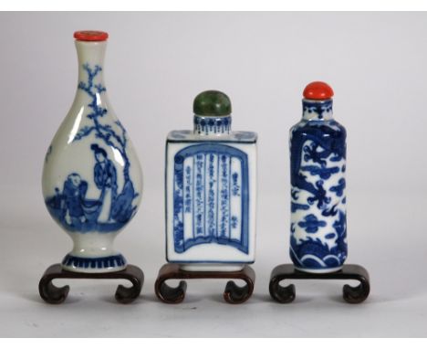 THREE CHINESE QING DYNASTY PORCELAIN BLUE AND WHITE SNUFF BOTTLES, one of flattened square form painted with a female sat rea