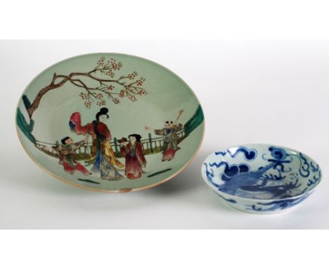 CHINESE CELADON GLAZED AND ENAMELLED PORCELAIN DISH, of shallow, footed form painted with figures at leisure in a fenced gard