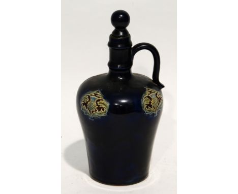 AN EARLY 1900's ROYAL DOULTON (LAMBETH) stoneware whiskey flask with ceramic topped cork stopper, the blue glaze reserved wit