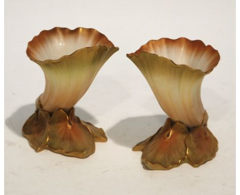 PAIR OF EARLY TWENTIETH CENTURY ROYAL WORCESTER BLUSH CHINA VASES, each modelled as a trumpet shaped flower head on base of t