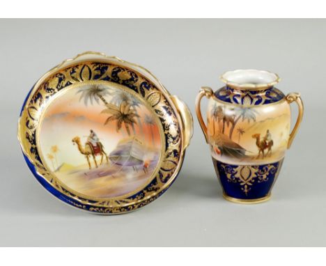 A 1930's JAPANESE NORITAKE PORCELAIN TWO HANDLED SHALLOW BOWL, decorated with a North African bedouin scene within Royal blue