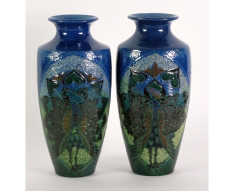 PAIR OF CHARLES BRANNAM LTD. MOULDED POTTERY VASES, each of tapering, high shouldered form with waisted necks, decorated in t
