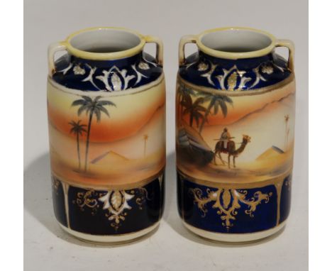 A PAIR OF 1930'S JAPANESE NORITAKE porcelain rounded cylindrical two handled vases decorated with Egyptian landscapes 6 1/2" 