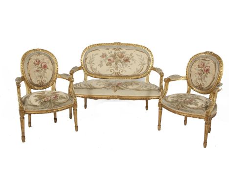 A SUITE OF LOUIS QUINZE STYLE SEAT FURNITURE, comprising a compact canape and a pair of armchairs, the giltwood frames carved