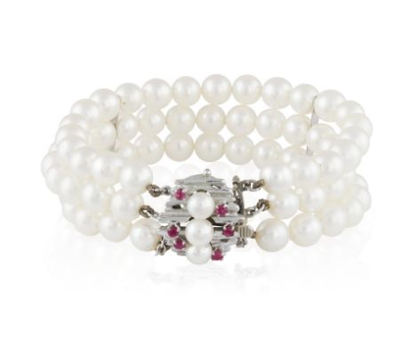 A CULTURED PEARL BRACELET WITH RUBY CLASP, composed of three rows of round-shaped cultured pearls of white tint measuring app