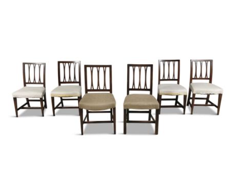A MATCHED SET OF SEVEN IRISH MAHOGANY FORK BACK DINING CHAIRS, c.1800, with mixed cream and buff fabric seats