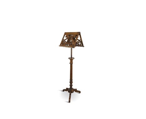 A SIMULATED ROSEWOOD ADJUSTABLE MUSIC STAND, 19TH CENTURYThe tilt tops with pierced lyre decoration and candlestick holders, 