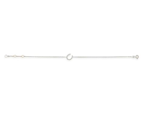 A DIAMOND BRACELET, the cable-link chain centring a horseshoe link pavé-set with brilliant-cut diamonds, mounted in 18K gold,